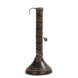 18th Century candlestick, the spiral iron holder above a turned fruitwood stand