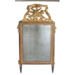 French late 18th Century wall mirror, surmounted by a pierced pediment featuring a trumpet and a