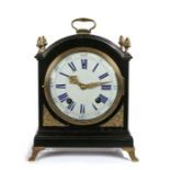 19th Century mantel clock, the ebonised case with an arched top and gilt swing handle, a gilt