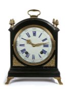 19th Century mantel clock, the ebonised case with an arched top and gilt swing handle, a gilt