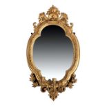 19th Century gilt gesso girandole, the shaped mirror plate with a confirming edge surmounted by a