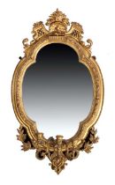 19th Century gilt gesso girandole, the shaped mirror plate with a confirming edge surmounted by a