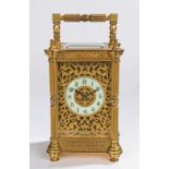Early 20th Century brass carriage clock, the case with reeded pilasters flanking a pierced