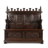 Gothic style oak hallway bench, the pediment with leaf capped arches flanked by turned finials above