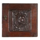 16th Century carved oak Romayne panel, with a profile facing right among a wreath and scrolls,