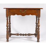 Charles II oak side table, the rectangular top above a long frieze drawer and turned legs united