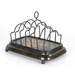 19th Century Pontypool toleware toast rack, the seven bar rack with flower decoration above a