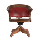 Early 20th Century oak swivel desk chair, of large proportions, the arched pad back above a solid