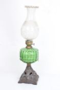 Falks British Make oil lamp, the foliate etched shade above a green glass reservoir and pierced