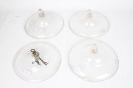 Four clear glass oil lamp smoke bells, the largest 23cm diameter (4)