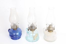 E. Miller Co. hand oil lamp with blue glass reservoir, two similar oil lamps (3)