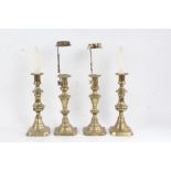 Pair of Victorian brass candlestick, with tapering stems, domed lower sections and square bases,
