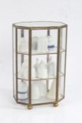 Collection of 16 porcelain candle snuffers, housed in a small glass display cabinet (17)
