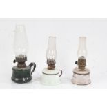 "LITTLE BUTTER CUP" oil lamp, the clear glass chimney above a green glass reservoir, 21cm high,