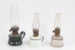 "LITTLE BUTTER CUP" oil lamp, the clear glass chimney above a green glass reservoir, 21cm high,