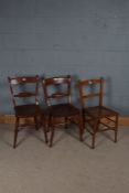 Pair of elm seated blade backed kitchen chairs, and a cane seated bedroom chair (3)