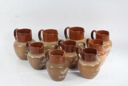 Collection of nine stoneware jugs advertising Cadbury chocolate, all with Cadbury tree logo to the