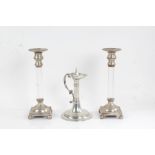 Pair of silver plate mounted candlesticks, the plated drip pans with gadrooned borders above clear