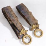 Two 19th Century bell pulls, with gilt metal loops and oak leaf decorated ends attached to the