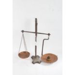 Pair of cast iron balance scales, with copper pans and small set of six brass weights
