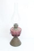 Venus Lamp Works oil lamp, with clear glass chimney and purple glass reservoir, on a scroll embossed