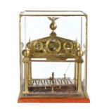 Mid 20th Congreve rolling ball block by Paul Lester, the brass eagle finial above a central