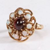 9 Carat Gold, opal and garnet ring, in the form of a flower head, with a central garnet surrounded