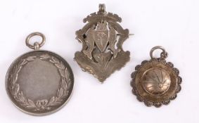Three Silver Badges, one depicting a family crest another depicting a football with "I & D. F. L.