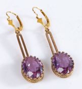 Pair of Yellow metal and deep purple colored glass earrings, with oval stones, weight 5.4 grams