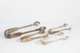 Four pairs of George IV and later silver sugar tongs, to include pair with talon form terminals, 3oz