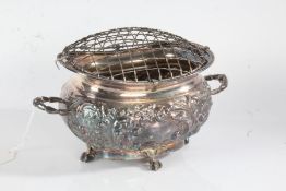 Silver plated flower bowl, the domed mesh cover above a twin handled body with embossed foliate