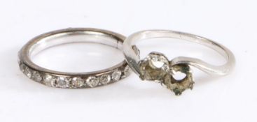 White coloured metal eternity ring set with a band of diamonds (three missing), ring size L, white