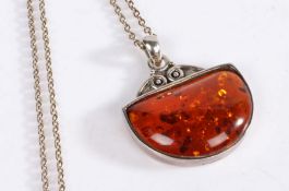 Orange amber necklace set on a white metal mount and chain