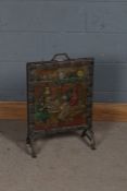 Painted brass embossed fire screen, depicting figure in a tavern, 67cm tall