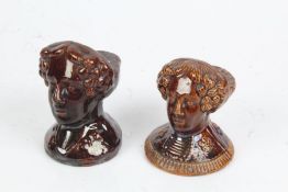 Two treacle glazed furniture feet, modelled as female busts, 11cm high