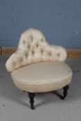 Late Victorian button back chair, having shaped back and raised on four ebonised legs and castors,