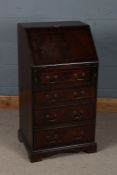 Mahogany effect ladies writing bureau, of narrow proportions, the sloping fall with fitted interior,