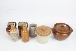 Stoneware to include two crocks, Doulton jug, pint tankard, two bottles with Cirencester labels (7)