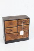 Apprentice style chest of four short and one long drawer, with marquetry inlaid drawer fronts,