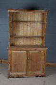 20th century stripped pine dresser, the plate rack raised on two door cupboard base, 180cm tall,