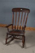 20th century beech Windsor rocking chair, with slatted back rest and open elbow rests, 103cm high