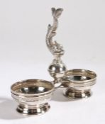 Spanish silver table salt, the central cast dolphin with tail raised, flanking two circular salts,