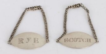 Pair of Chinese export silver decanter labels, the oval labels engraved RYE and SCOTCH, on chains