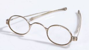 Pair of George III silver spectacles, marks rubbed, with oval lenses and folding arms
