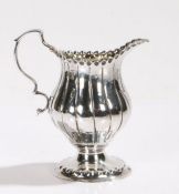 George III silver cream jug, London, marks rubbed, maker WC, the bulbous reeded body with double