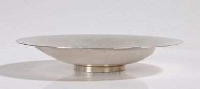Danish sterling silver dish, of beaten circular form, raised on a circular foot, 16.5cm diameter,