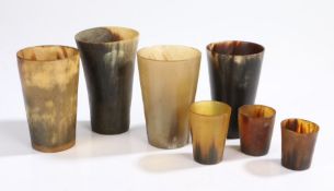 A collection of 19th Century horn cups/beakers, four larger and three smaller of tapering form,