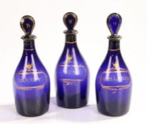 Three George III period glass Bristol Blue decanters, with gilt text RUM, BRANDY and HOLLANDS,
