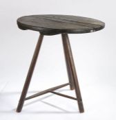 Primitive cricket table, the circular top above three angled legs united by stretchers, 51cm wide,