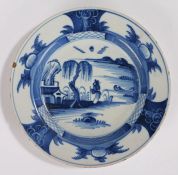 18th Century Delft plate, with a figure looking up at a tree and building, 23cm wide